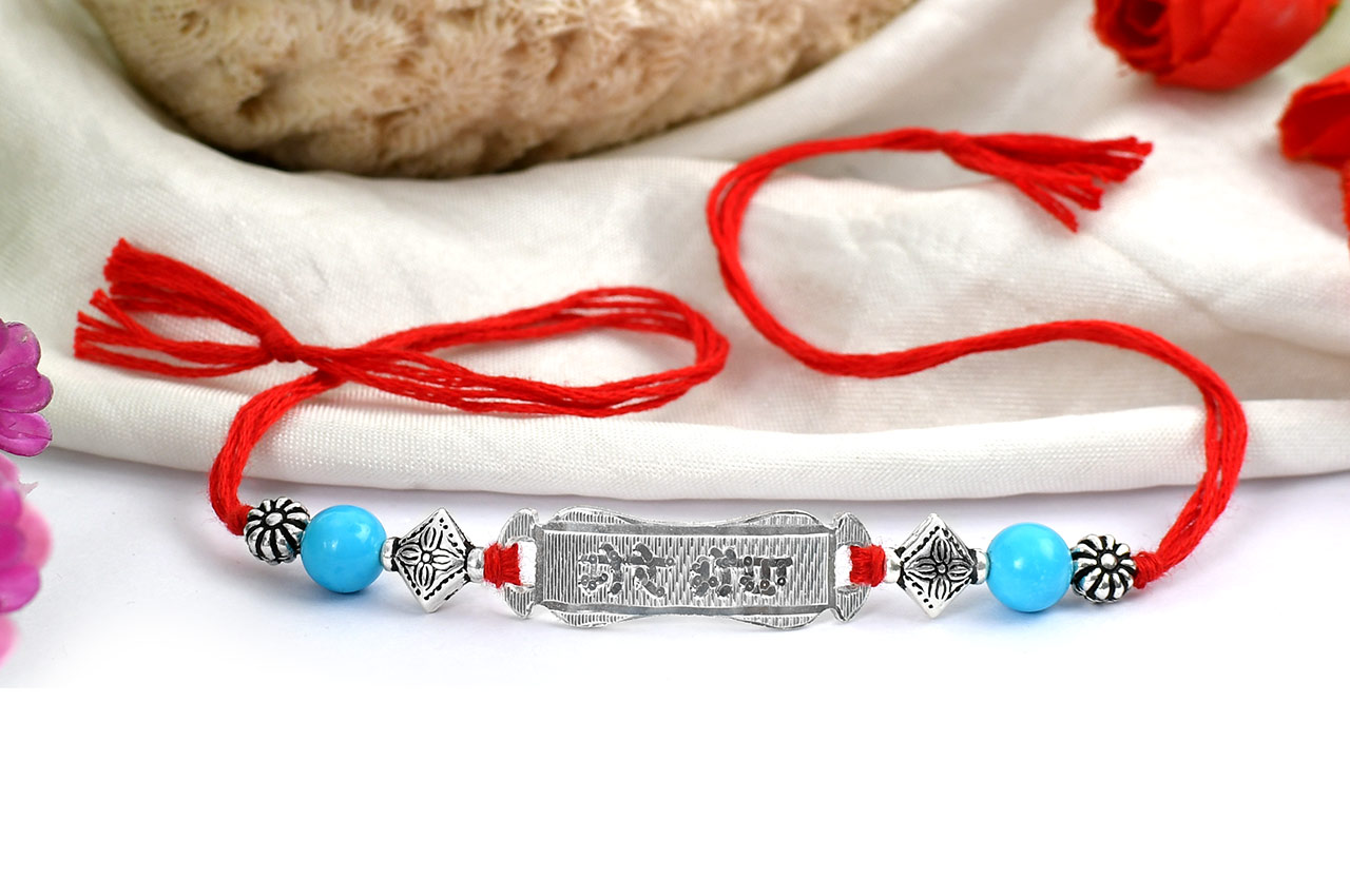 Turquoise beads Rakhi with pure silver accessories in thread