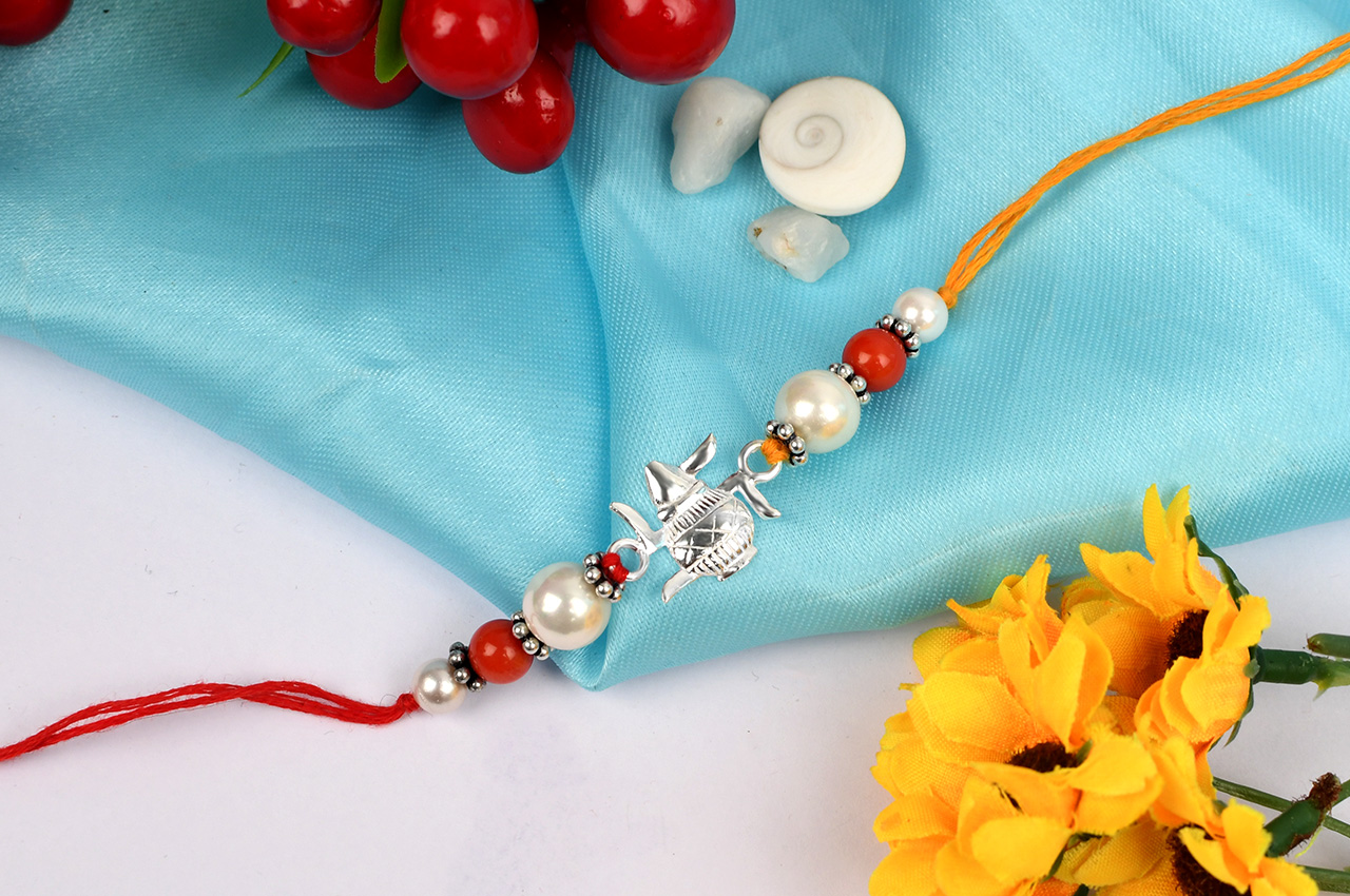 Kalash Swastik Rakhi With Coral and Pearl